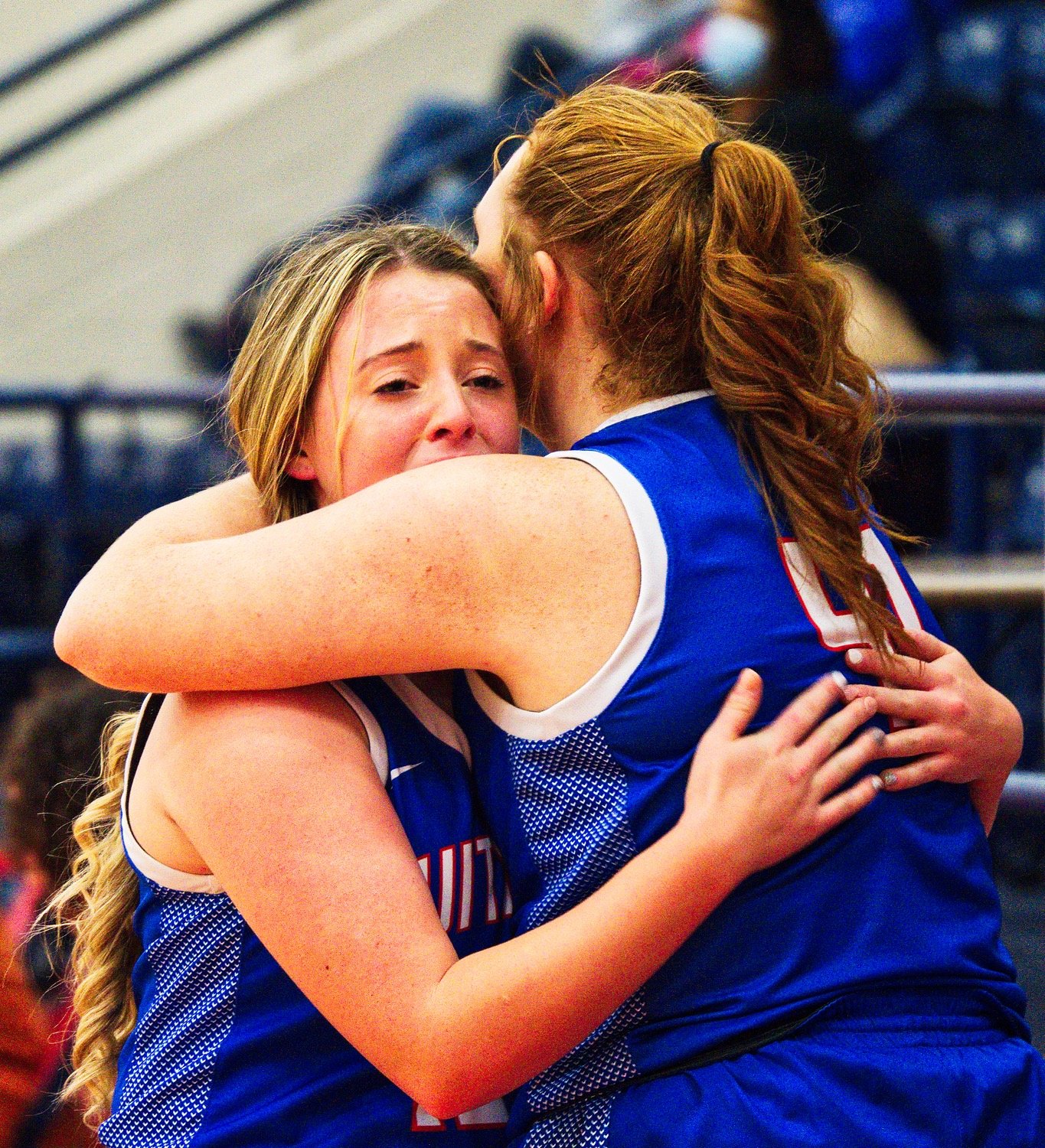 Reiny Luman, right, embraces senior Kynlee Love as she comes to the bench for the final time as a Lady Bulldog. [see more shots, score a print]